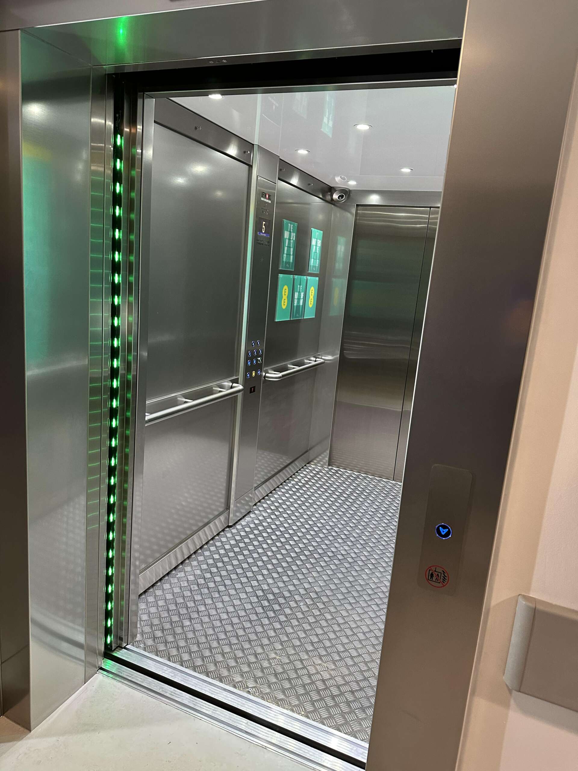 an elevator with doors and green lights