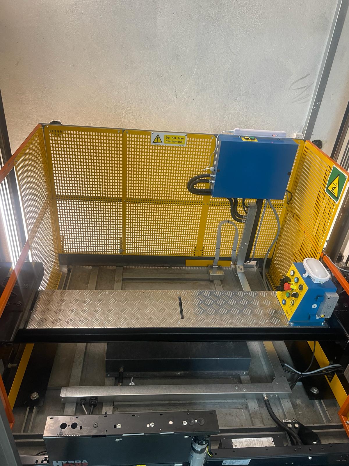 a machine with a blue box and a yellow cage