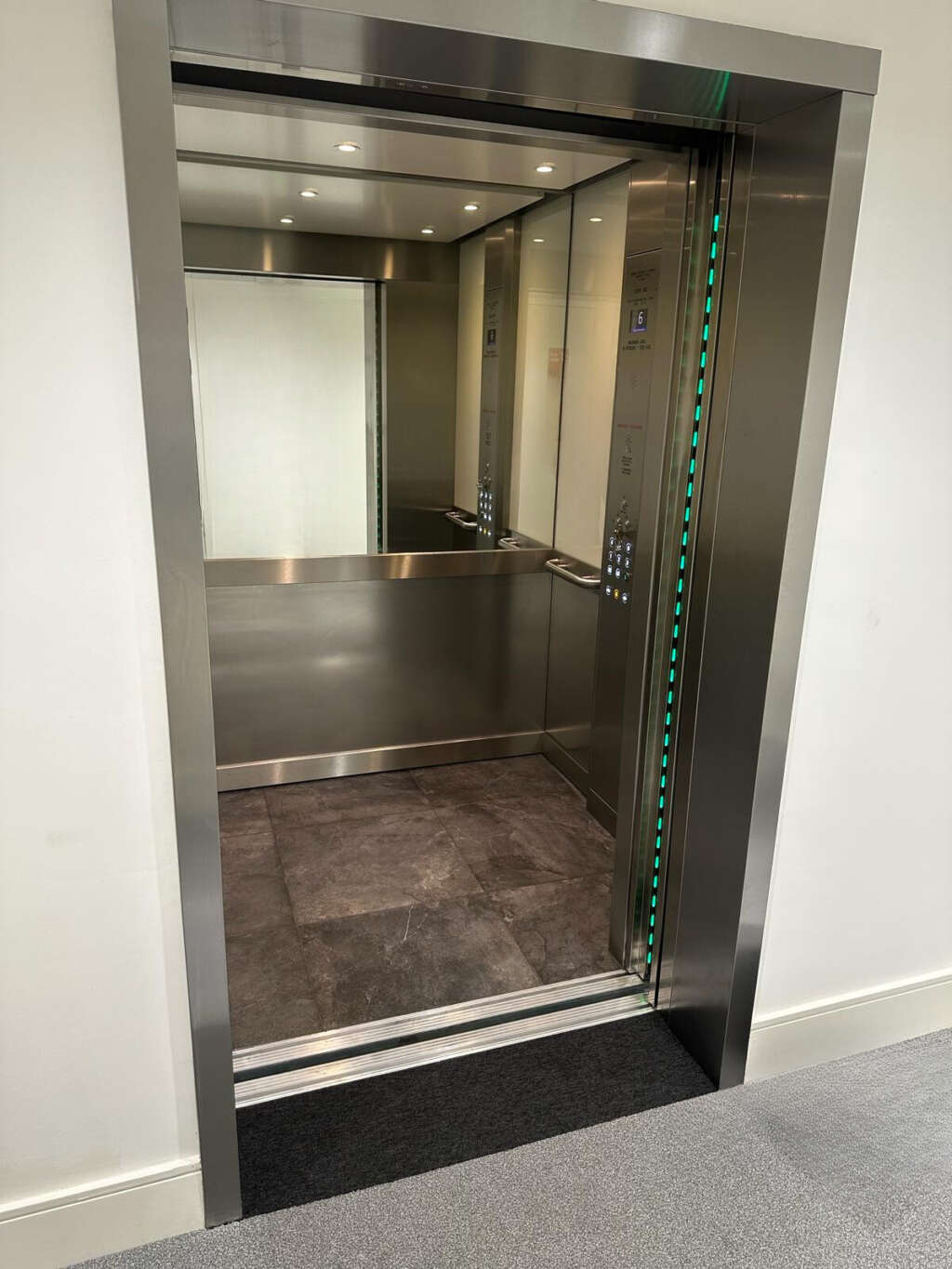 an elevator with glass doors